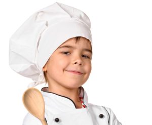 girl chef with wooden spoon isolated on white background